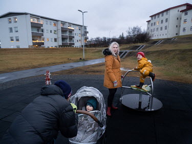 Lilja Karen Kjartansdottir (blond hair) with her son Juli Antonio Aronsson in a children's play area. With her career on hold due to the pandemic, Kjartansdottir knew Iceland's generous parental leave...