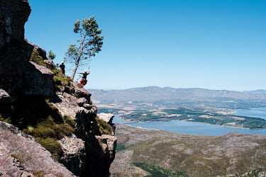 Rope Technician Olwethu Gcakamani, a member of a high-angle tree clearing team, on a cliff face in a remote montane catchment area that feeds the Theewaterskloof dam. The teams are deployed on two-wee...