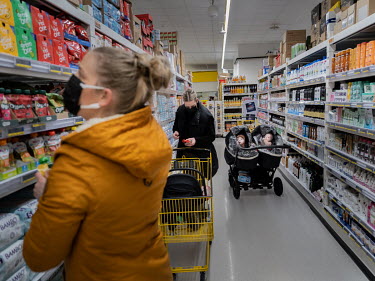 Drifa Hrund Guomundsdottir with her twins Baldur Logi and Brynja Lill out shopping.  Guomundsdottir said that 'usually (my daughters) would be busy with friends or sports', but during COVID lockdowns...