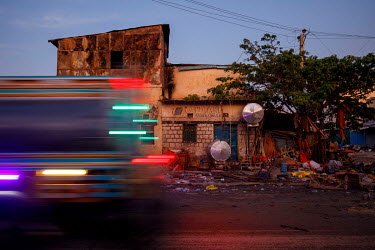 A public bus passes one of the many damaged houses at the Waheen market after a huge fire tore through what had been home to an estimated 2,000 shops and stalls. According to officials about two dozen...