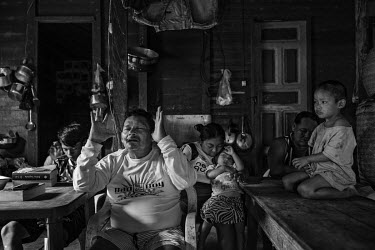 Riwu Jumi Kanamari, an indigenous Indian man, celebrates a Christian evangelical service with his family and friends at his home in Atalaia do Norte in the Javari Valley. The growing religious fanatic...