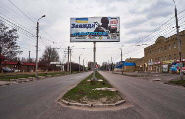 A billboard on an empty Centralna Street that reads: 'Always Ready with links to sites like Patriots Donbasa and Donpatriot News.'