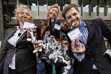 Suited protestors spilled fake plastic 'nurdles', oil and cash amongst discarded fishing waste while 'dirty scrubbers' tried to greenwash the pollution as Ocean Rebellion activists protest two issues...