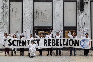 Scientists from Extinction Rebellion, including 93 Year old Arnold, flypost Shell's London headquarters with scientific papers on climate change.