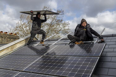 Workers installing solar photovoltaic (PV) panels on an 1890s terraced house in Southwark.
