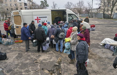 People, who have been hiding in bomb shelters for several weeks, leave the House of Culture where they have gathered to get transport out of the city using evacuation minibuses organised by volunteers...