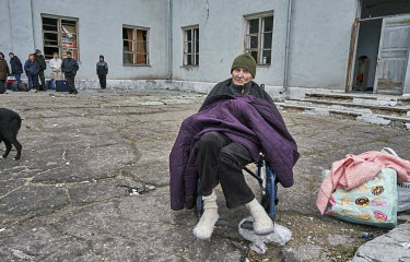 Antonin, one of a group of people at the House of Culture where they have gathered to get transport out of the city, waits for an evacuation minibus organised by volunteers from SOS Vostok.