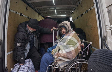 People squeeze onto evacuation transport to leave the city using a minibus organised by volunteers from SOS Vostok. The evacuees have been hiding in basements for at least two or three weeks, enduring...