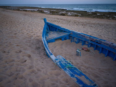 An abandoned boat on a beach near the village of Vejer de la Frontera where migrants often land after crossing the Mediterranean from north Africa.