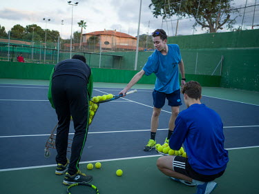 A trainer with two youths at the Real Tennis Club of Murcia where Carlos Alcaraz (who as of 4 April 2022 is ranked world number 11) started training.