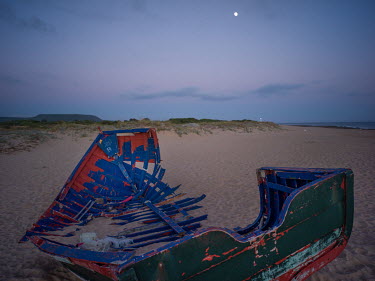An abandoned boat on a beach near the village of Vejer de la Frontera where migrants often land after crossing the Mediterranean from north Africa.