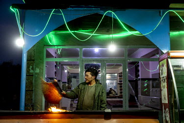 A kebab stall illuminated at night.