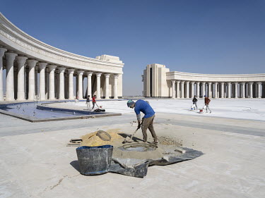 Workers at the newly built Arc de Triomphe in Egypt's New Administrative Capital.  Following persistent problems of overpopulation, pollution and traffic congestion, the construction of a giant new sa...
