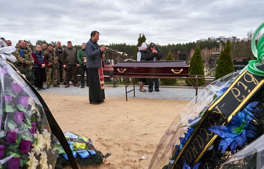 A priest stands beside the coffin during the funeral of soldier, Zhenya Pasechnik (41), who was killed during shelling on 6 March 2022 in Irpin. His mother (Natasha) said her son was buried in front o...