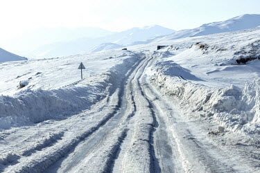 A snow covered road between Bamyan and Maidan Shar winding through the Kuhi Baba mountains.