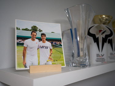 A photo with Roger Federer and trophies in the bedroom of tennis prodigy Carlos Alcaraz at the family home in El Palmar. As of 4 April 2022 Carlos Alcaraz is ranked world number 11.
