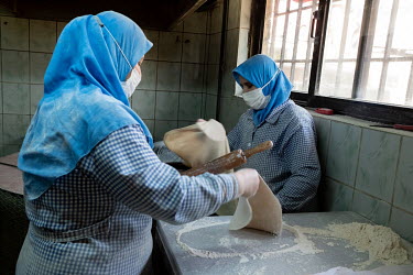 Women make bread in the kitchens of the Erzincan Tandir Evi, a traditional restaurant serving food from the central-eastern city of Erzincan, and the migrant community now living in Kurtulus.