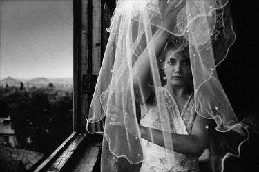 Irina Slakar preparing her veil on her wedding day. She is marrying Demitri, a former miner at the 'Socialist Donbass' coal mine.