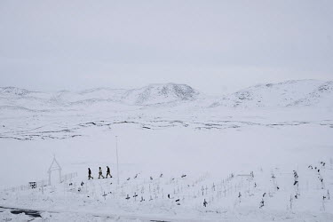 Workers leave Ilulissat's cemetery after preparing a tomb for a funeral.