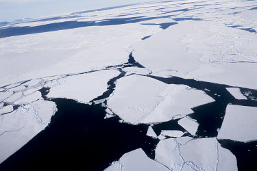 Huge cracks cleave the sea ice of Disko Bay into huge floating islands. Locals claim that this breaking up of the winter ice is a recent phenomenon which wasn't seen 20 years ago. It has also been sug...