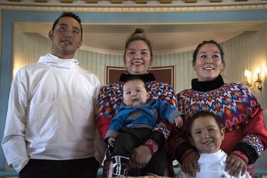 Inuit mothers and children in a church during a baptism ceremony.