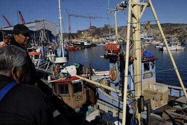 Fishermen and their trawlers in the harbour.