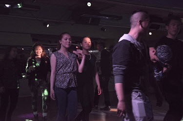 Young people dancing on a Saturday night at a youth club.
