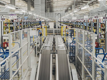 The interior of Amazon's 'BHX1' fulfilment centre. Conveyor belts move parcels through the facility, ready for dispatch.