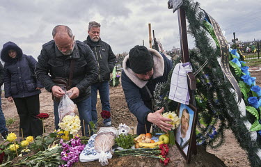 The mother of Rudenko Denis Oleksandrovich (38) places her hand on her son's picture during his funeral. Denis used to be a member of Anti-Terrorist Operation (ATO), and when Russian Forces attacked U...