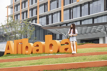 An employee in a garden outside at the Alibaba Group Holding Ltd. headquarters.