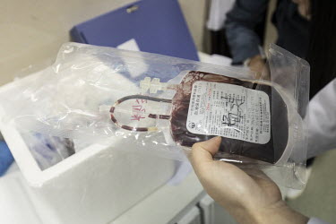 An Anhui Kedgene Biotechnology employee handles blood from cancer patients taking part in genetic treatment trials at the company's lab in Hefei. The samples will be used to develop therapies for the...