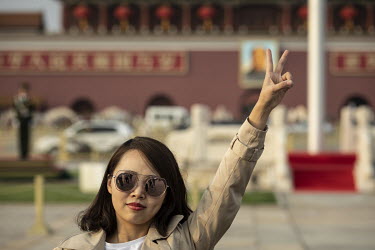 A woman visiting Tiananmen Square during the Chinese Communist Party's congress in the Great Hall of the People.