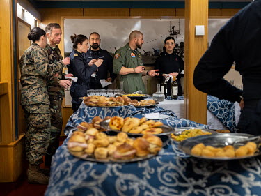 Various NATO military socialise with food and wine on the Italian aircraft carrier Giuseppe Garibaldi during 'Cold Response 2022' (CR 22), a Norwegian military exercise involving invited allies and pa...