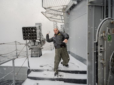 A helicopter pilot throws a snowball on the Italian aircraft carrier Giuseppe Garibaldi during 'Cold Response 2022' (CR 22), a Norwegian military exercise involving invited allies and partner nations...