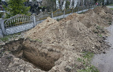 New dug graves prepared for civilians killed during the Russian occupation of Bucha.