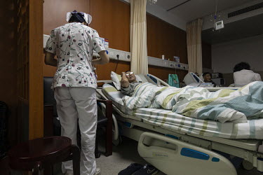 A cancer patient taking part in a genetic treatment trial lies in bed at a hospital in Hangzhou. Unhampered by rules, China is racing ahead of the west in gene-editing treatments for illness such as c...