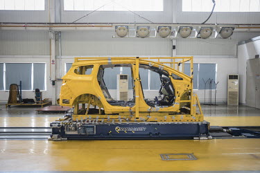 A vehicle chassis sits on a Seattle Safety LLC testing sled in a lab at the BYD (Build Your Dreams) headquarters.
