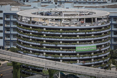 A circular vehicle charging tower in the campus of BYD (Build Your Dreams) headquarters.