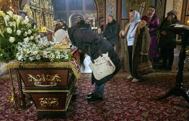 A woman kisses an icon on Orthodox Good Friday in Saint Sophia Cathedral.