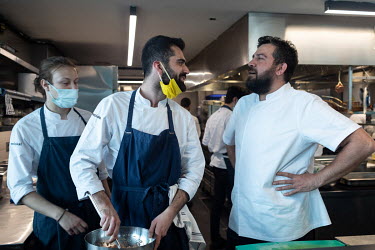 Turkish chef Maksut Askar (R) talks with kitchen staff in his restaurant, NeoLokal, inside the SALT Galata museum.