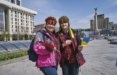 Tanya (left) and Natulya, holding Ukrainian national and Ukrainian nationalist movement flags, in Independence Square. In what used to be a very busy square before the Russian invasion, is today almos...
