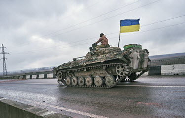 Ukrainian soldiers driving a tank near Irpin after the town was liberated from Russian forces.