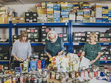 Sue Hodgkiss (left, 68), Naomi Gilbert (centre, 64) and Eva Upton (right, 63) sort through donations to the food bank at Rugeley Community Church. In 2012, the food bank was relatively new. Since then...