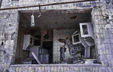 A broken window reveals a wrecked flat in a destroyed apartment block in the Obolon district. It was hit by a Russian shell in the early morning hours of 14 March 2022 killing two people and wounding...