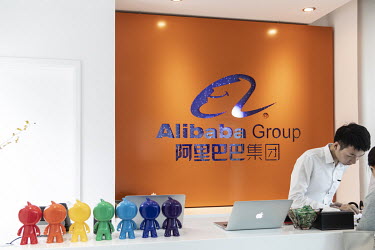 An employee stands behind the reception desk at the Alibaba Group Holding Ltd. headquarters in Hangzhou.