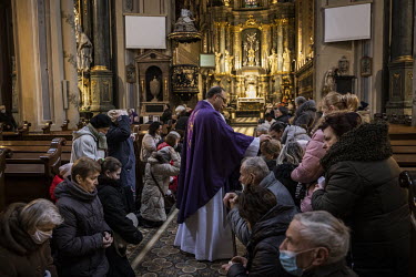 People are blessed by a priest during morning mass on Ash Wednesday at the Assumption of the Blessed Virgin Mary Catholic Cathedral.