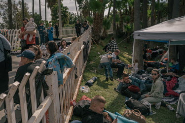 Ukrainian refugees rest at an encampment near the San Ysidro border crossing. Volunteers, many of them Ukrainians living in the United States have helped establish the camp that provides clothes, food...