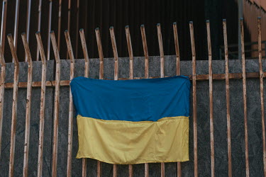 An Ukrainian flag attached to the border wall of separating the United States and Mexico.