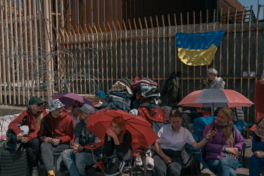 Ukrainian refugees wait to cross the border into the United States at an encampment near the San Ysidro border crossing where some Ukrainians have arrived after travelling for over a month.