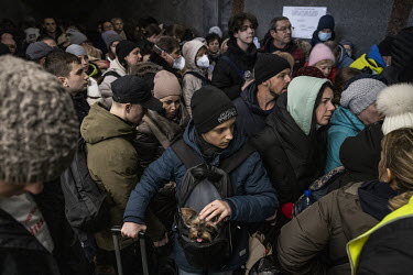 Hundreds of women and children crammed into the tunnels of Lviv train station wait to board evacuation trains out of Ukraine.